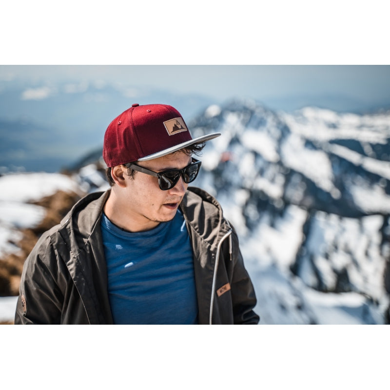 Snapback-Cap von Jumping Bird in Bordeaux-Grau mit geprägtem Lederoptik-Patch vorn und seitlichem Logostick
