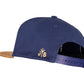 Snapback-Cap von Jumping Bird in Blau-Braun mit geprägtem Lederoptik-Patch vorn und seitlichem Logostick