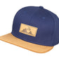 Snapback-Cap von Jumping Bird in Blau-Braun mit geprägtem Lederoptik-Patch vorn und seitlichem Logostick