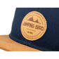 Snapback-Cap von Jumping Bird in Ozeanblau-Braun mit geprägtem Lederoptik-Patch vorn und seitlichem Logostick