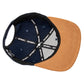 Snapback-Cap von Jumping Bird in Ozeanblau-Braun mit geprägtem Lederoptik-Patch vorn und seitlichem Logostick