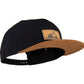 Snapback-Cap von Jumping Bird in Schwarz-Braun mit geprägtem Lederoptik-Patch vorn und seitlichem Logostick