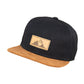 Snapback-Cap von Jumping Bird in Schwarz-Braun mit geprägtem Lederoptik-Patch vorn und seitlichem Logostick