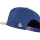 Snapback-Cap von Jumping Bird in Blau-Grau mit geprägtem Lederoptik-Patch vorn und seitlichem Logostick