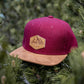Filz-Snapback von Jumping Bird in Dunkelrot-Braun mit geprägtem Lederoptik-Patch vorn und seitlichem Logostick