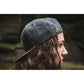 Snapback-Cap von Jumping Bird in Dunkelgrau-Braun mit geprägtem Lederoptik-Patch vorn und seitlichem Logostick